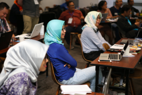 An image of a group of journalists attending a local training event led by our Google News Initiative team. The image focuses on three female Indonesian journalists, smiling.