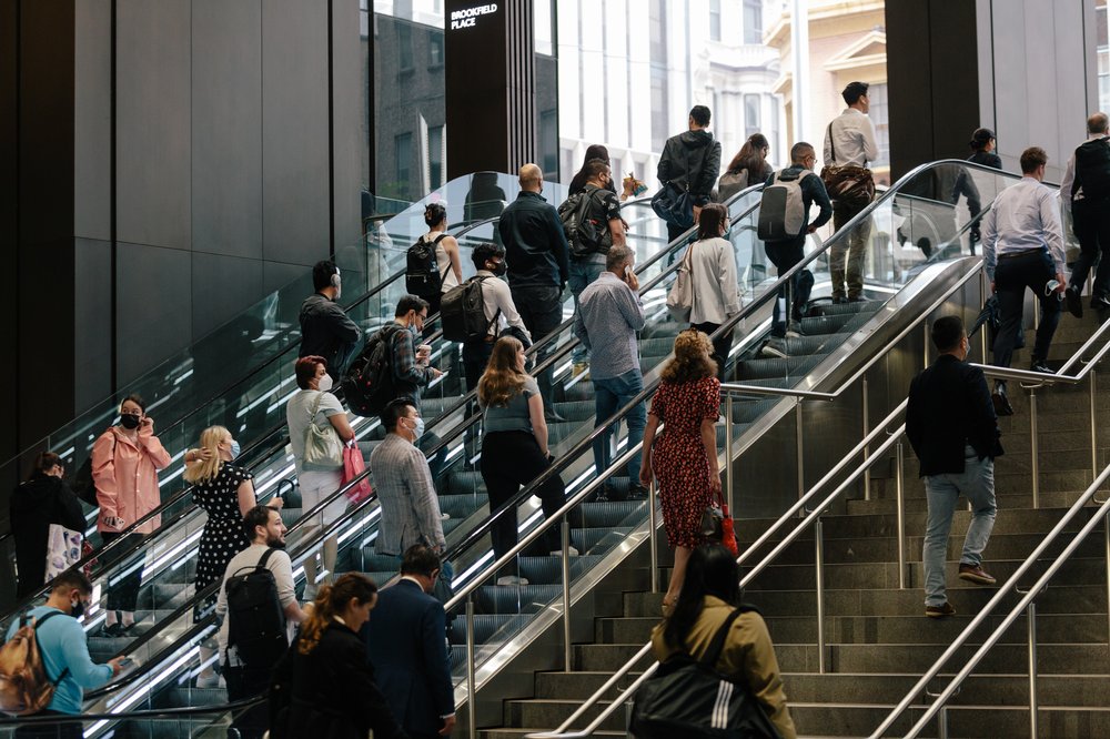 Passengers go up stairs in a crowded subway in Sydney