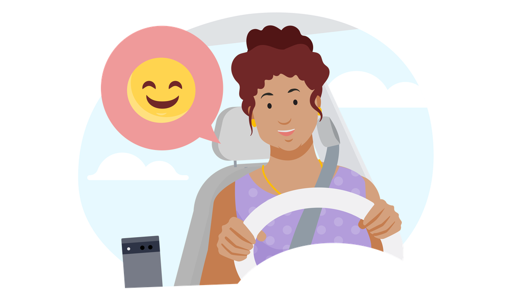 Illustration of a person driving in a car with their phone on the dashboard. A pink speech bubble with a smiley face indicates she’s dictating text to Google Assistant.